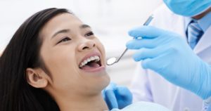 A woman getting get routine dental cleaning in Tacoma, WA