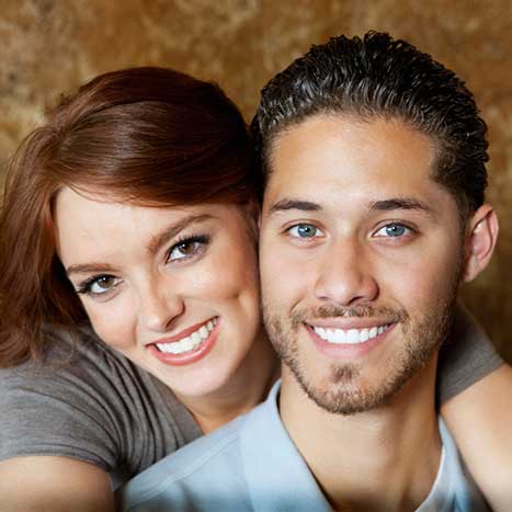 A couple smiling with white teeth