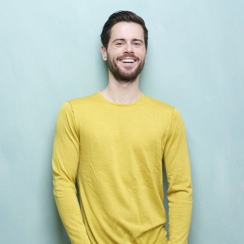 Young man smiling with yellow tshirt